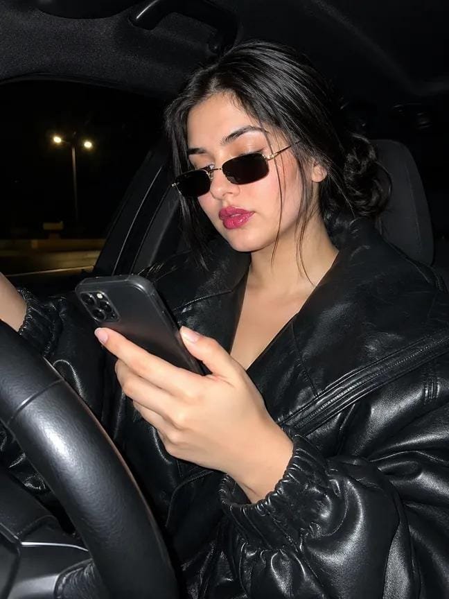 girl using mobile in the car